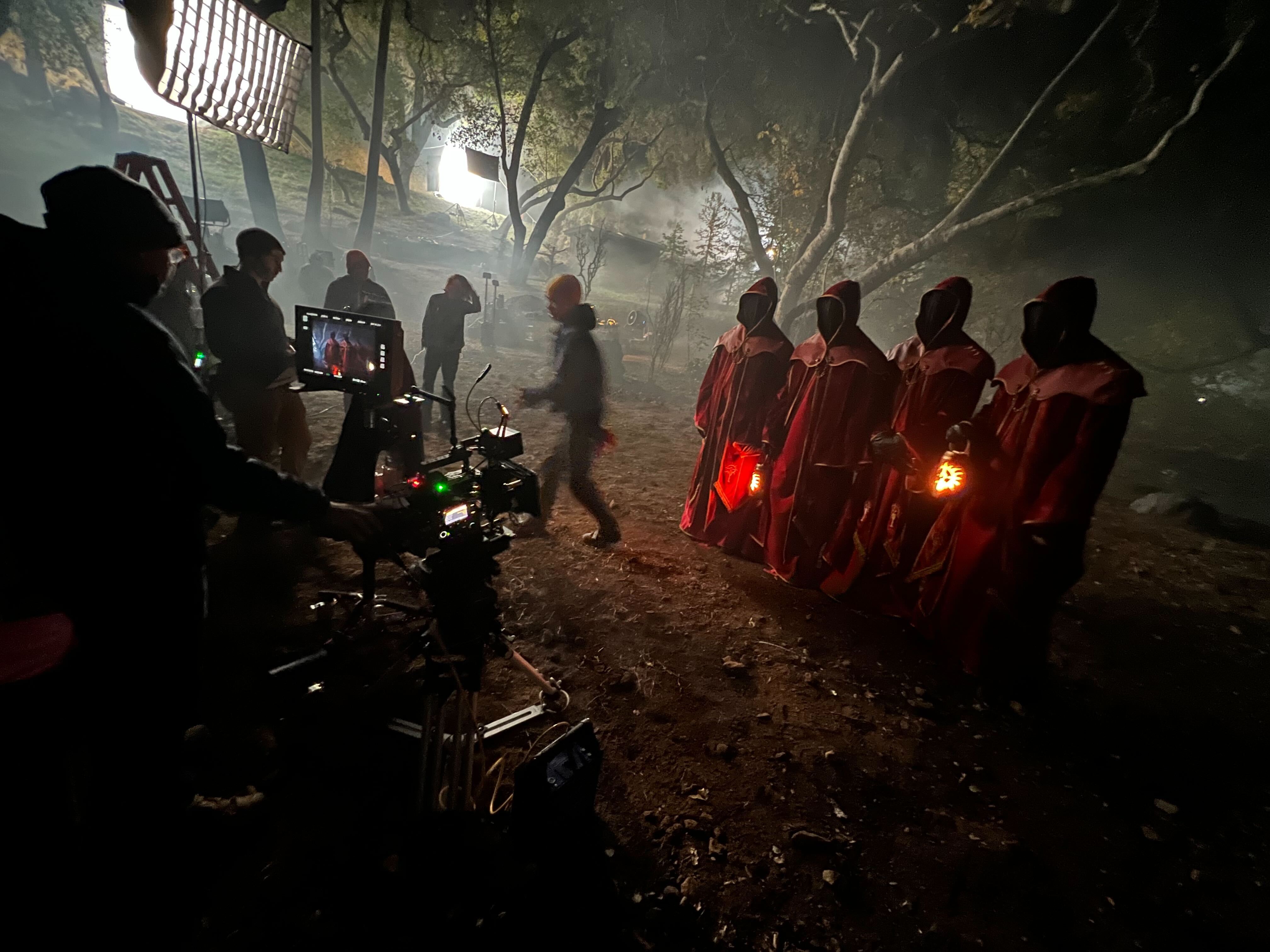 Camera, lighting, and hooded performers on the Diablo set