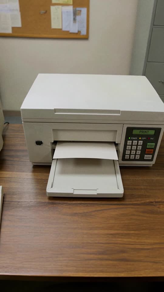 A vintage printer producing a page